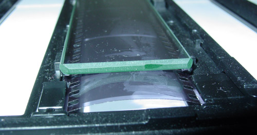 Film curl defeating the glass insert