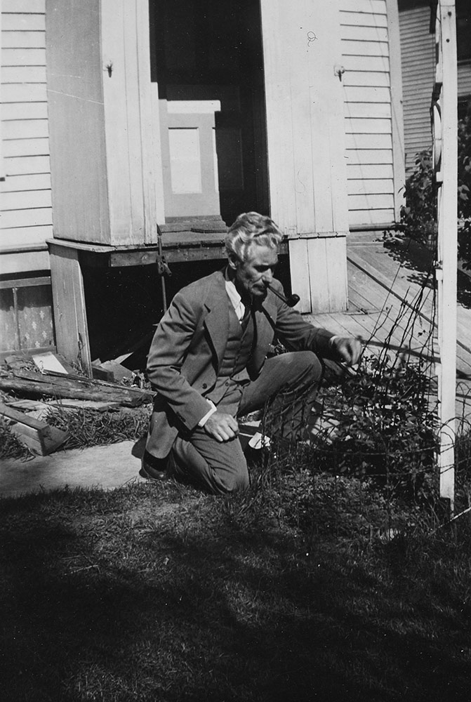 Man in a suit smoking in the garden