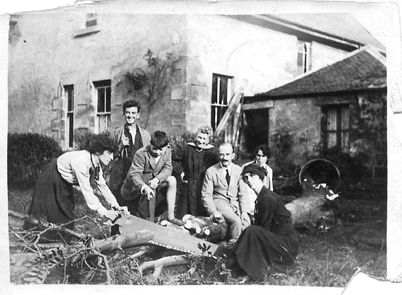 Two women sawing a tree