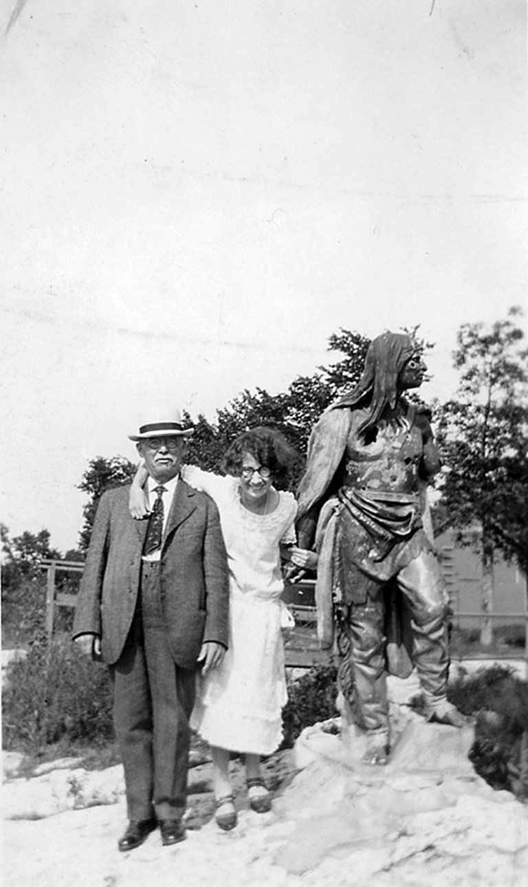 Man, Woman, and Indian Statue