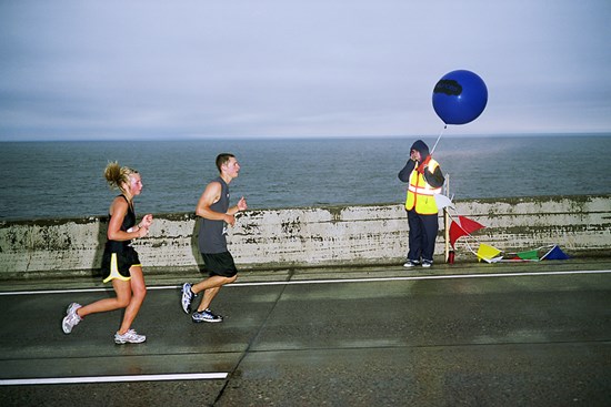 Two Runners And A Man With A Balloon