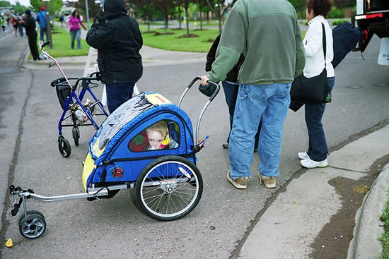 A Child Packed Into A Stroller