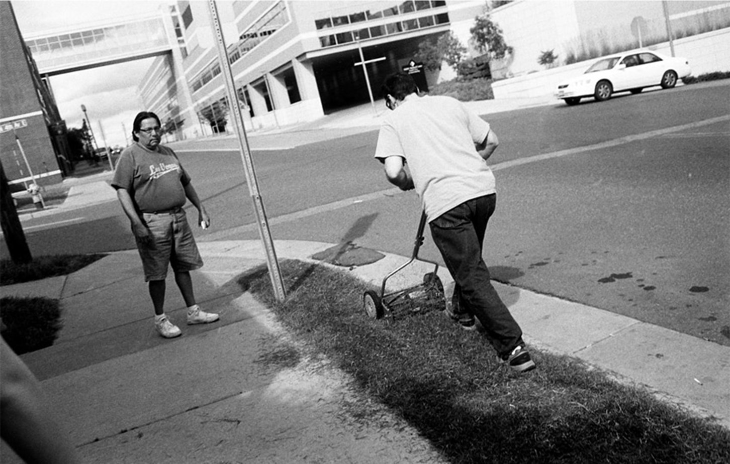 A Man Mows Some Grass