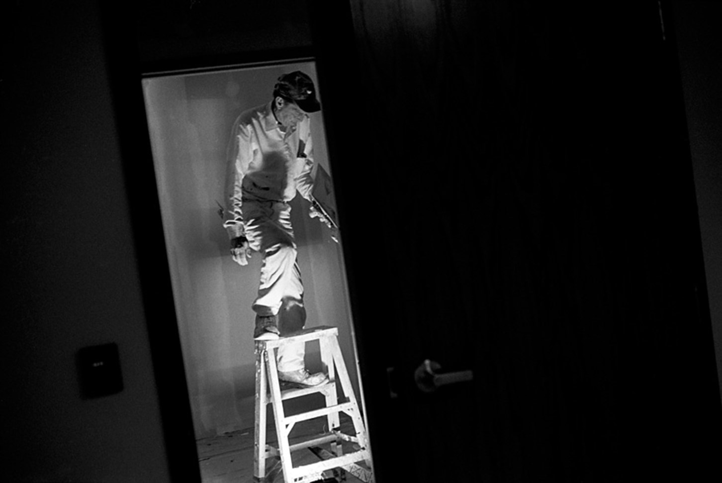 A Man Uses a Step Ladder