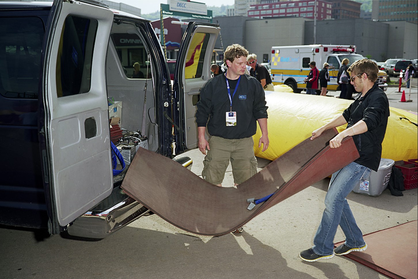 Two Men Setting Up The Finish Line