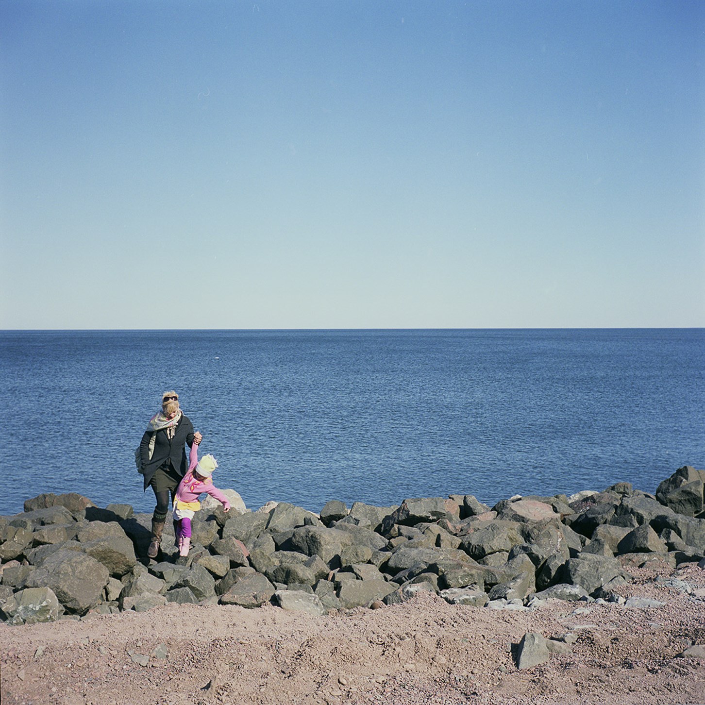 Helping a Child Over The Rocks, Duluth, Minnesota, March 2010